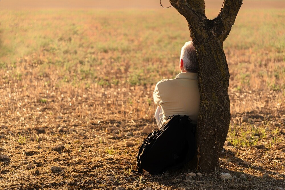 image of a man spend time in solitude reflecting on God's word and try to get away from his loneliness.