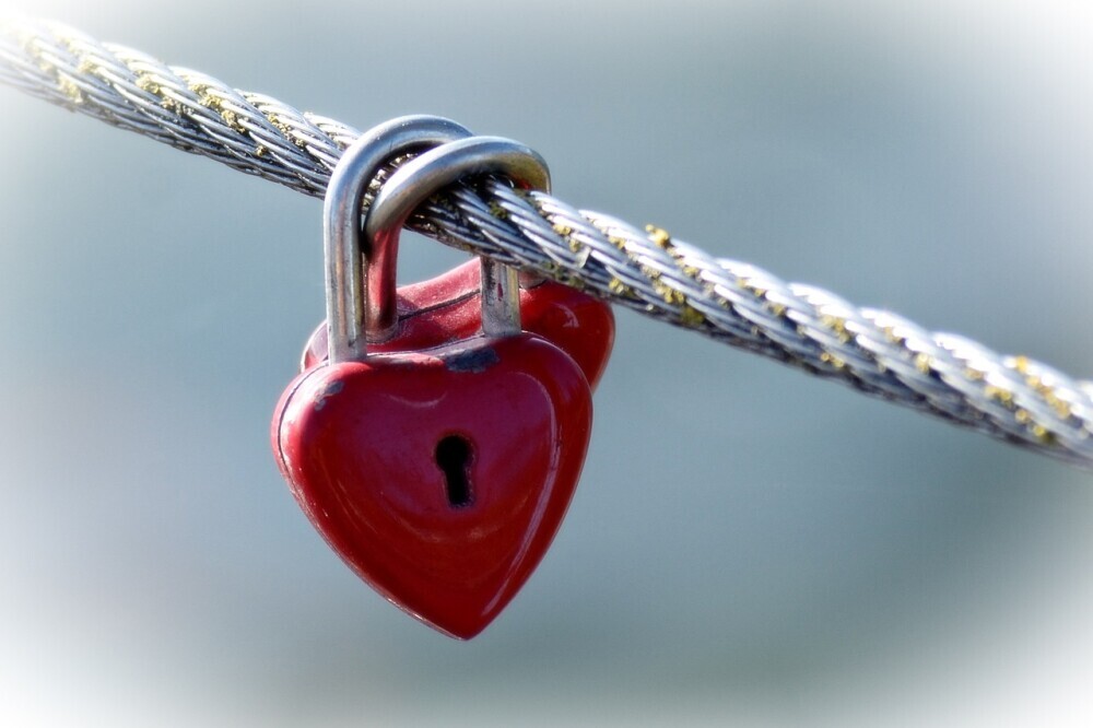 image of two red heart shaped locks locked together symbolizing the promises of God to restore restore our loneliness.