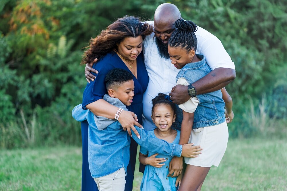 A joyful family cooking together, emphasizing teamwork and bonding while preparing a healthy meal. - Parenting