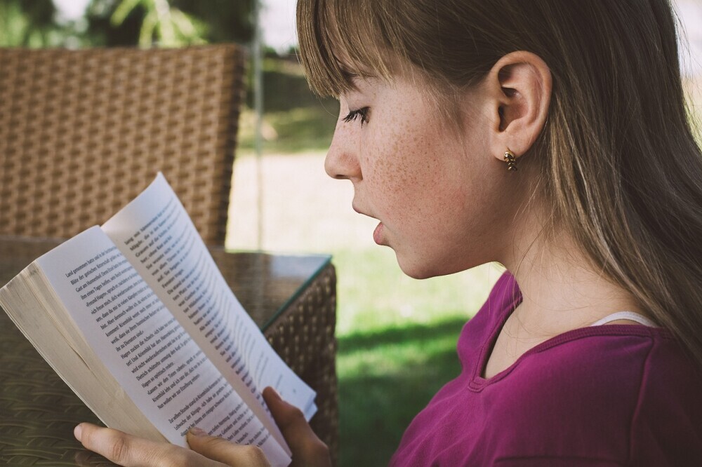 A loving parent reading a colorful bedtime story to their child, fostering a warm and nurturing bedtime routine.- Parenting