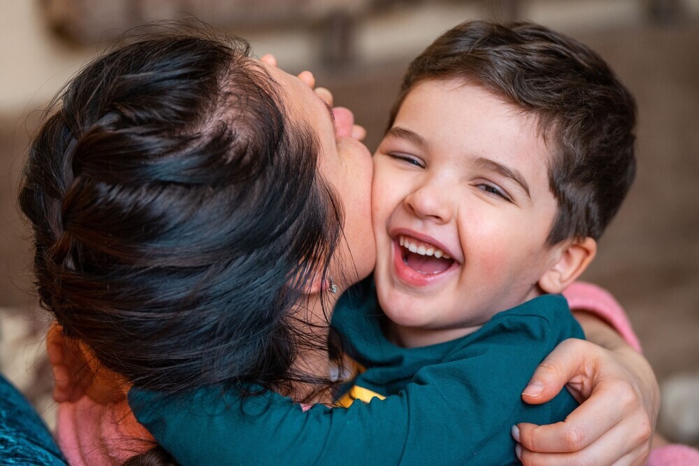 A parent and child happily playing in a park, illustrating the importance of outdoor activities and quality time together. - Parenting