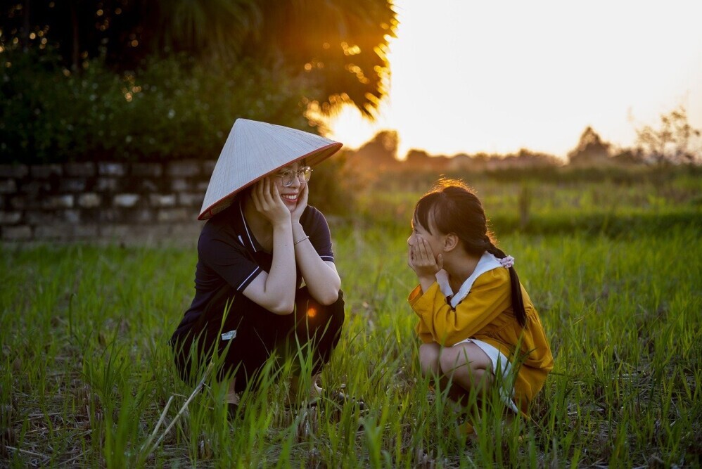 A patient parent assisting their child with homework, showing support and encouraging learning. - Parenting