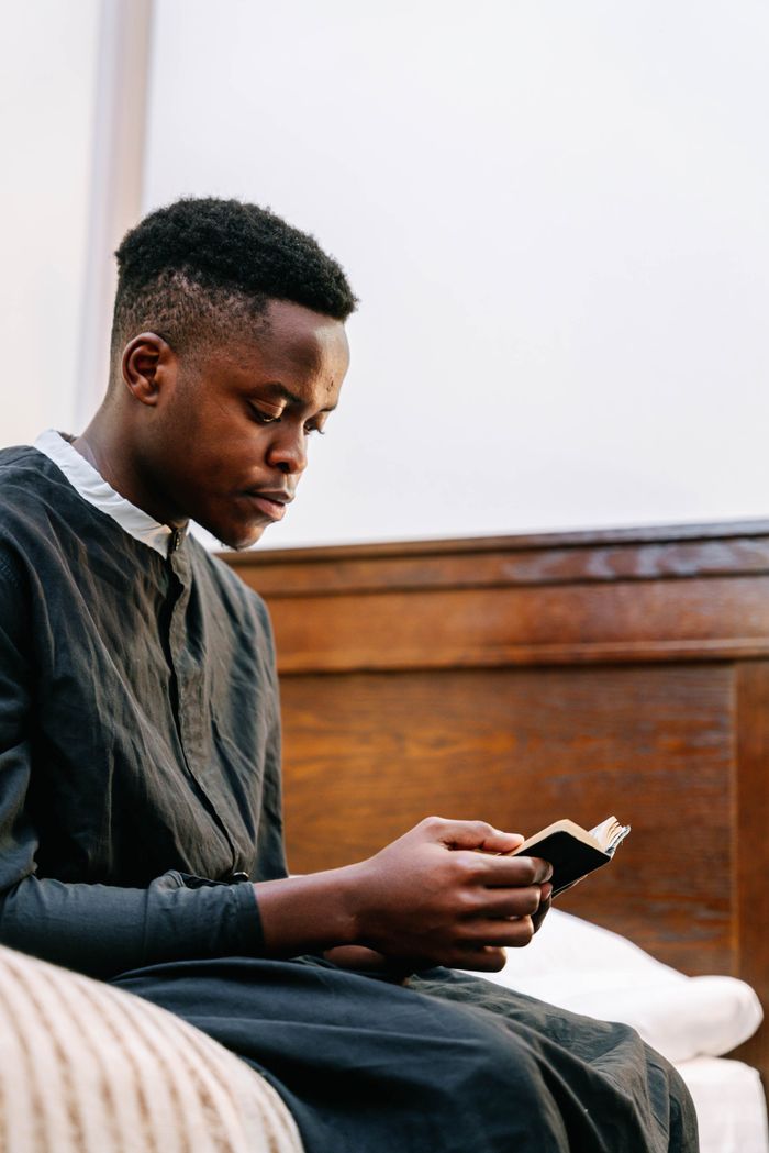 Peaceful image of a man reading a bible in a quiet setting, reflecting faith and solitude.